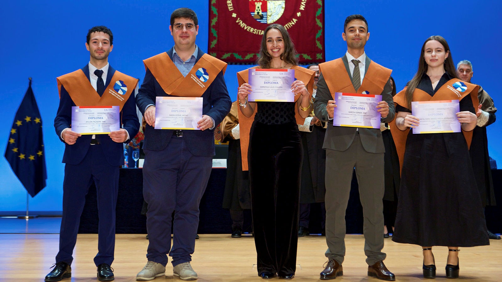 Receiving the diploma alongside four other fellow graduates.